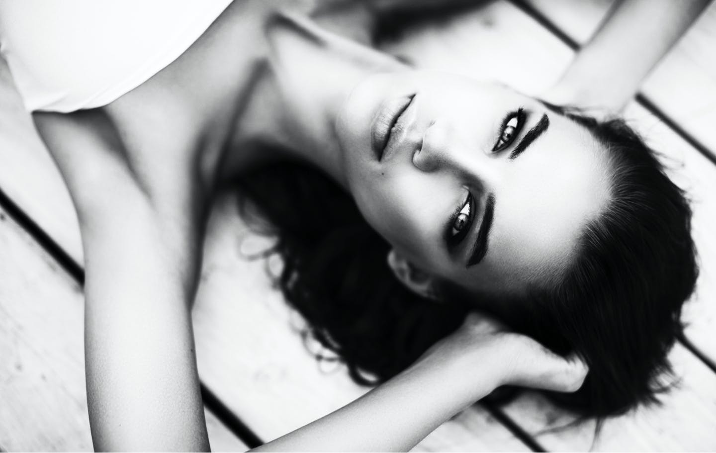 black and white photo of woman laying on floor