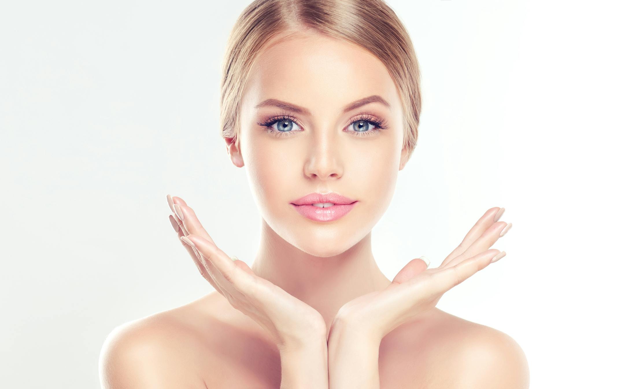Woman looking at camera with hands by her face