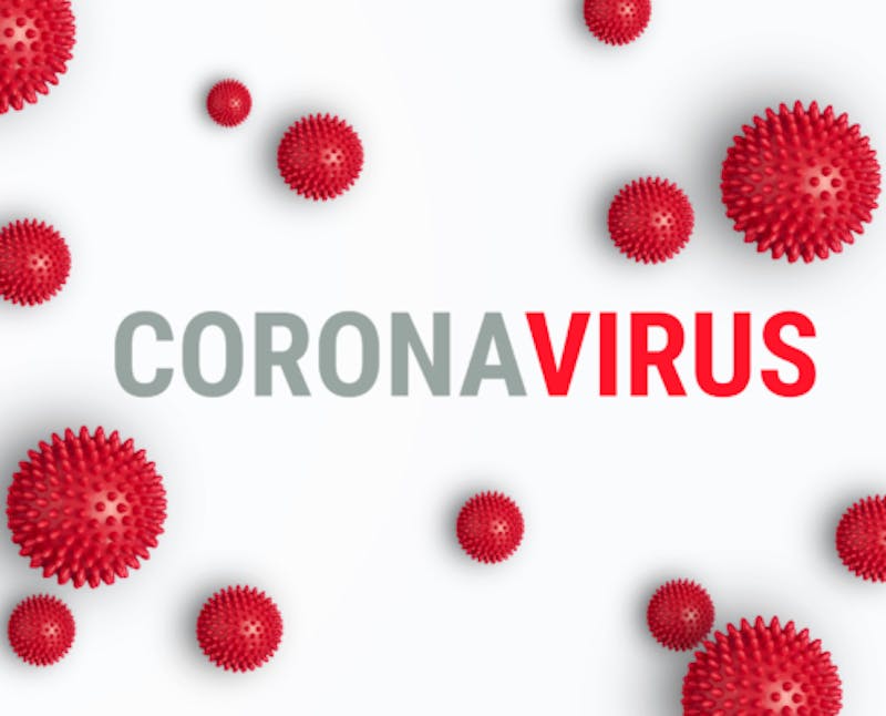 a red coronavirus text surrounded by red virus balls on a white background