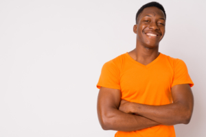 man posing for picture in orange t-shirt