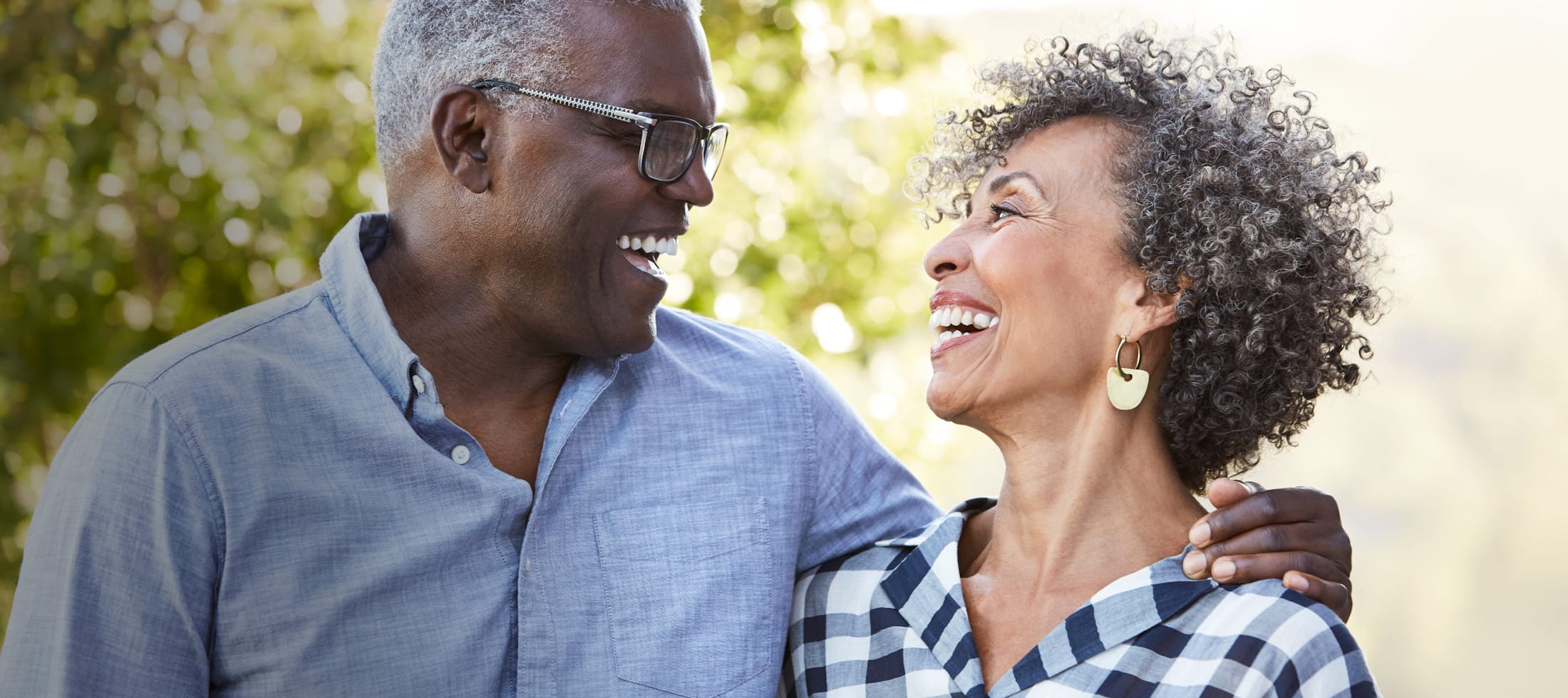 Older couple laughing while looking at eachother