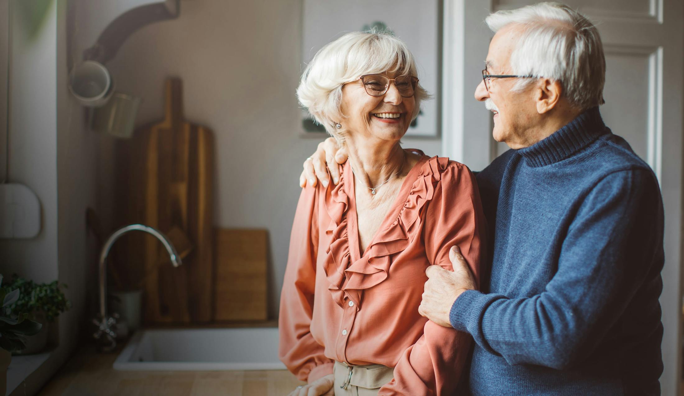 Older couple smiling while looking at eachother