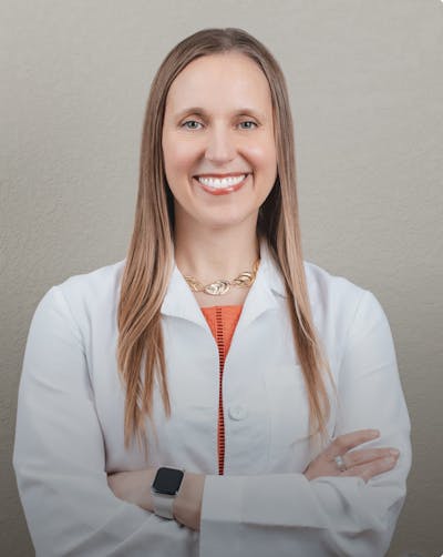 picture of woman in long brown hair in white coat