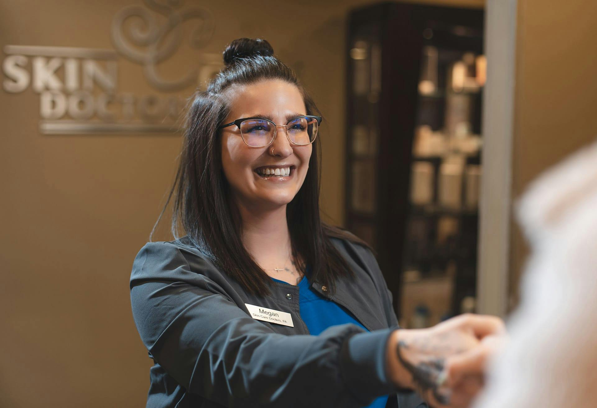 Staff shaking someone's hand