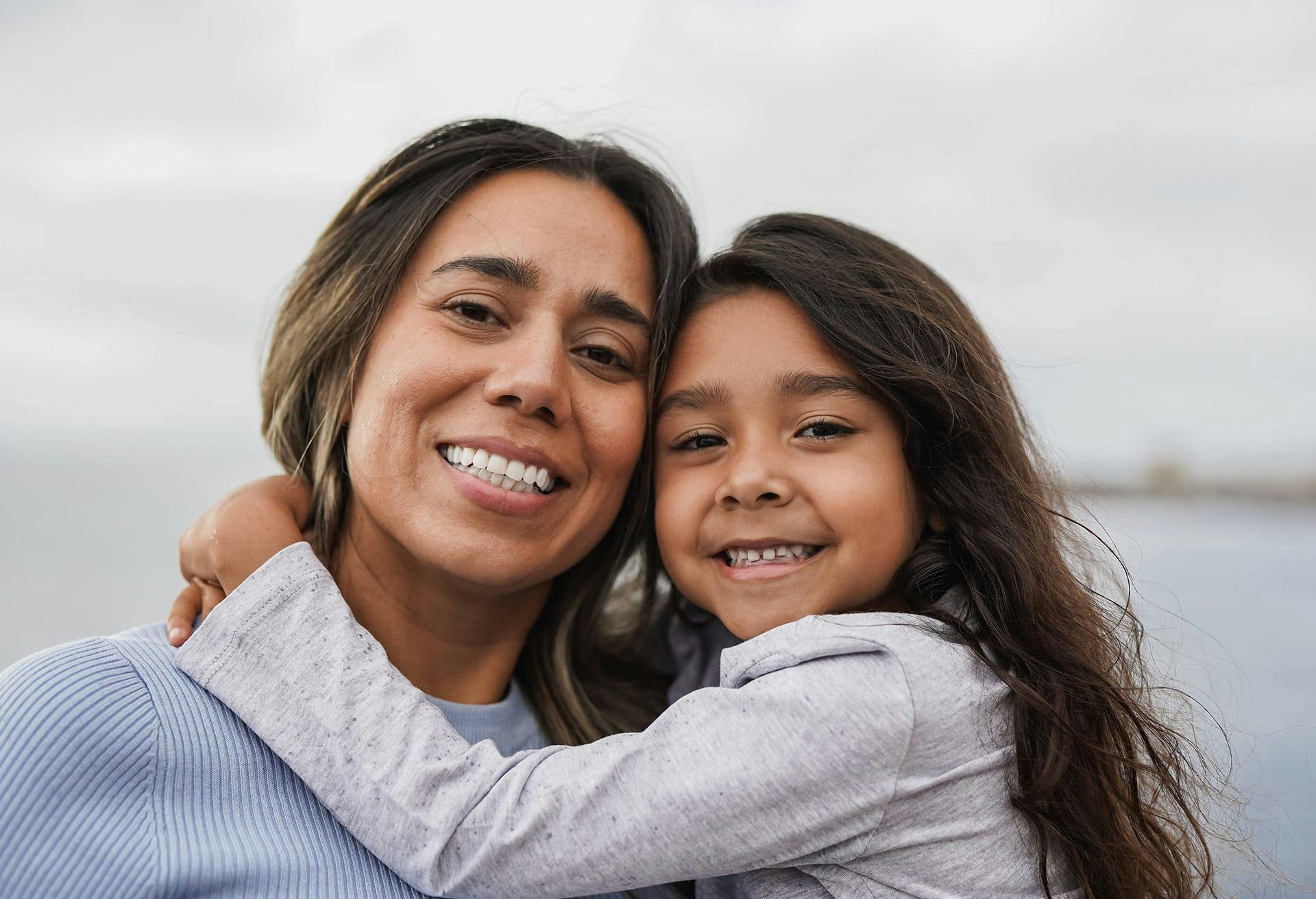 Mother and daughter smiling