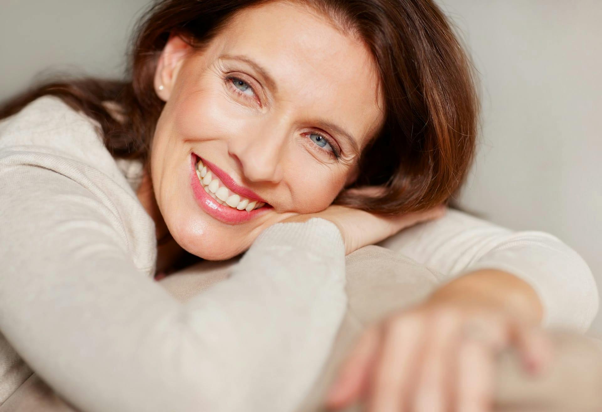 Woman with auburn hair smiling