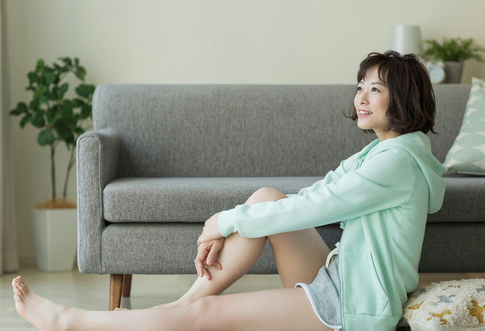 there is a woman sitting on the floor with her legs crossed