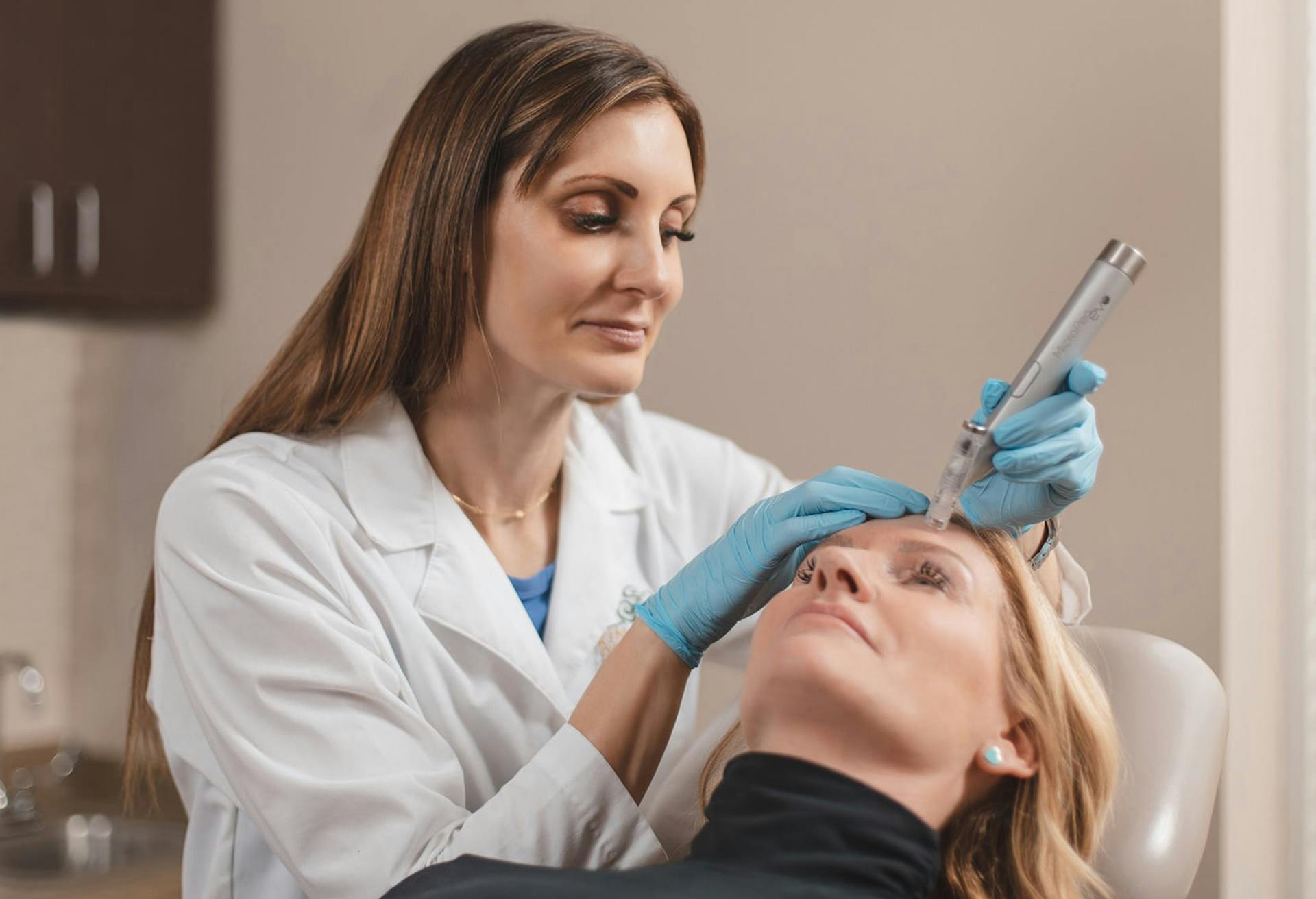Nadine Miller, PA-C with a female patient