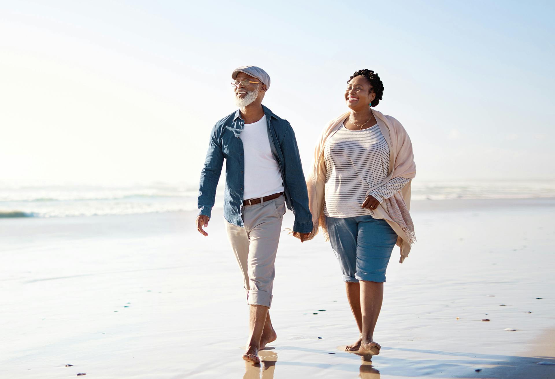 couple walking on the beach together holding hands