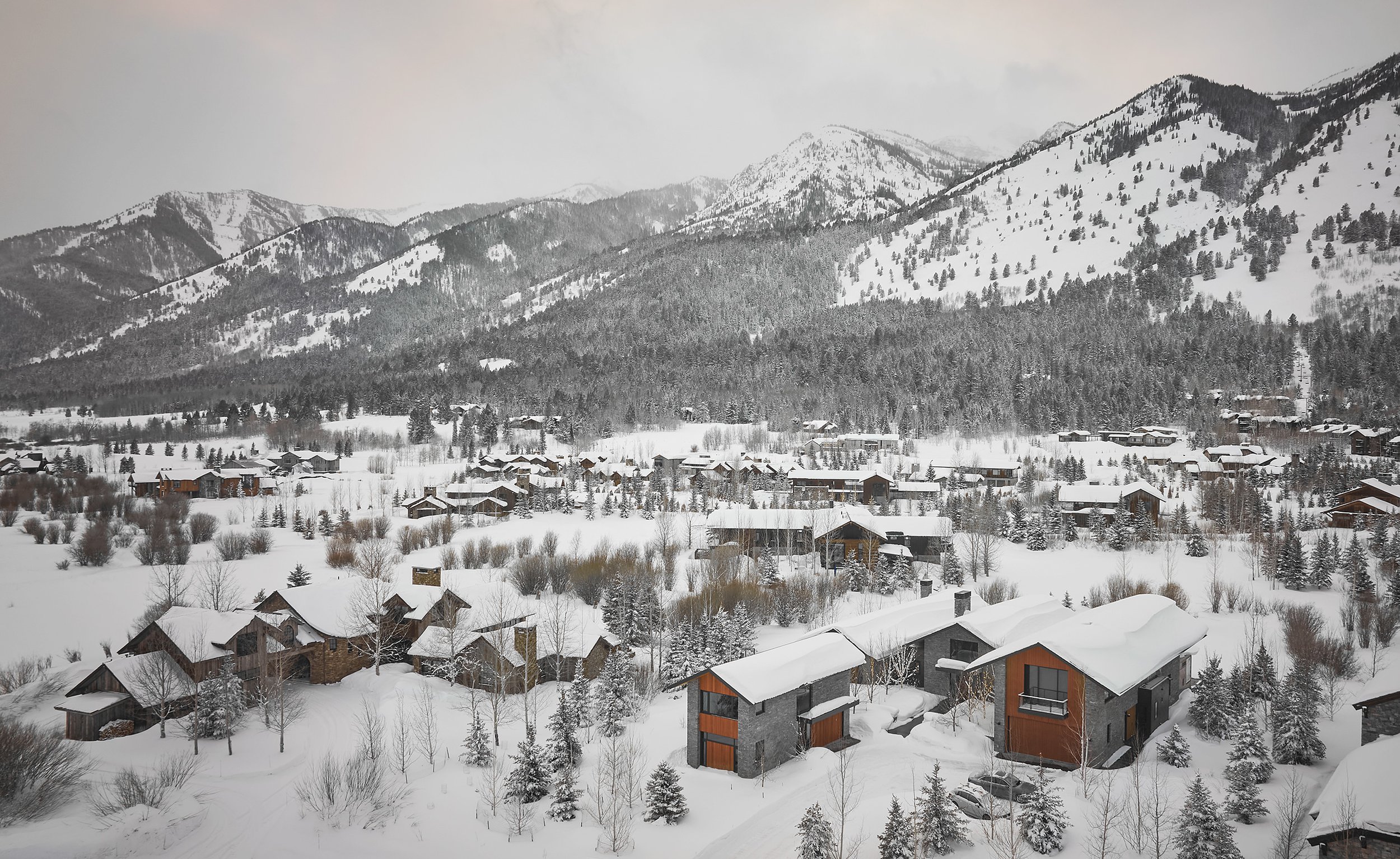 Drone view of a main and guest house at the base of Teton Village