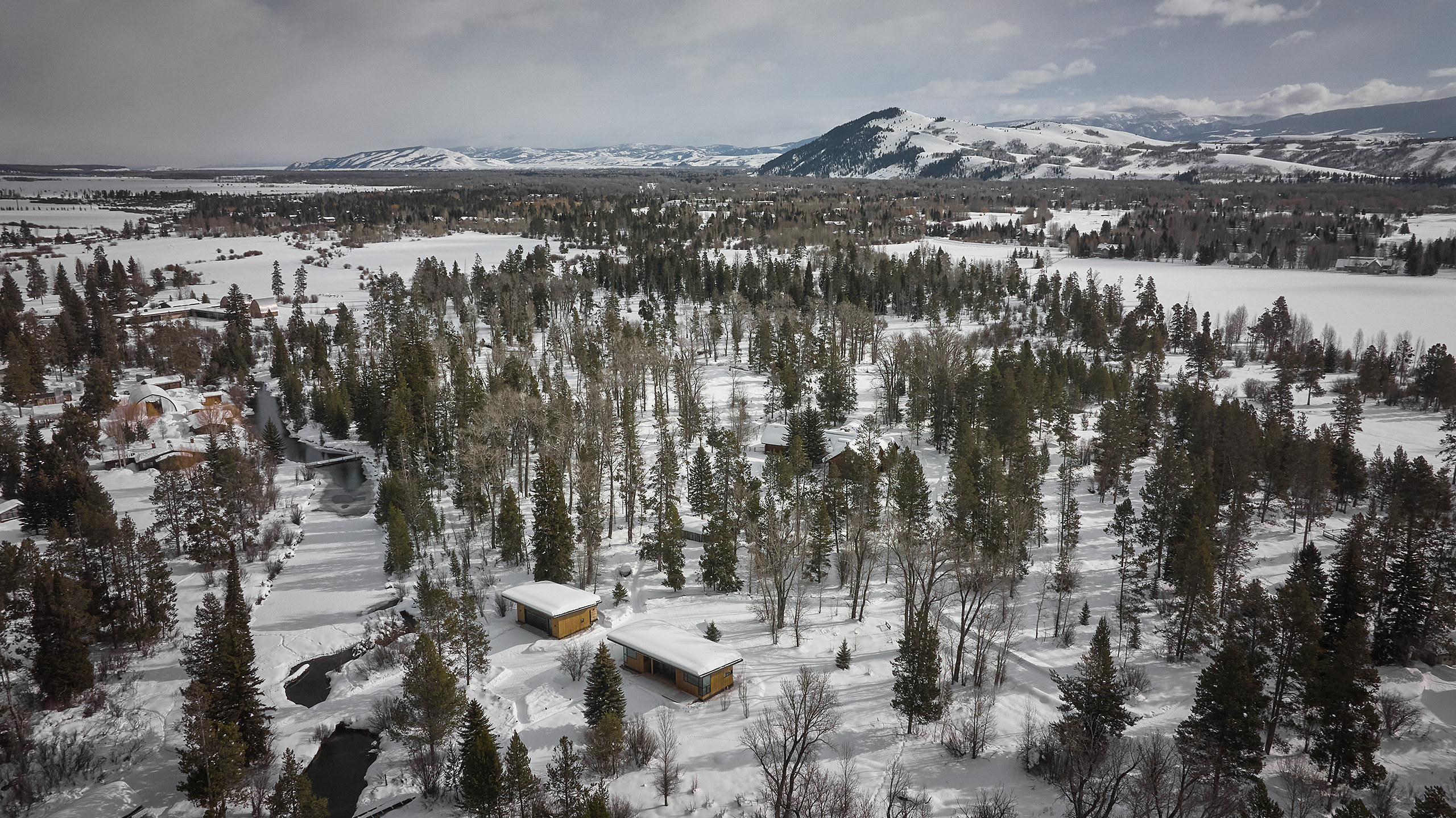 Drone view of guest house surrounded by trees in Wilson, Wyoming