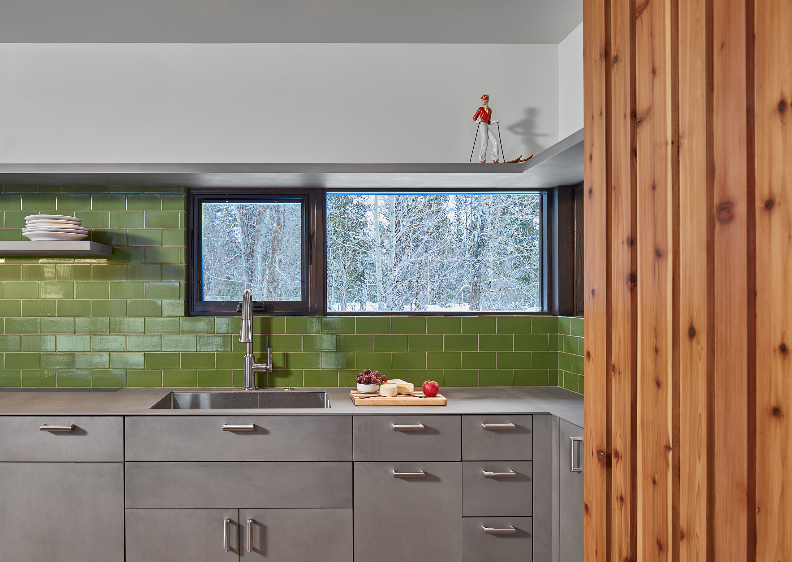 Guest house kitchenette cedar, metal, and green subway tile