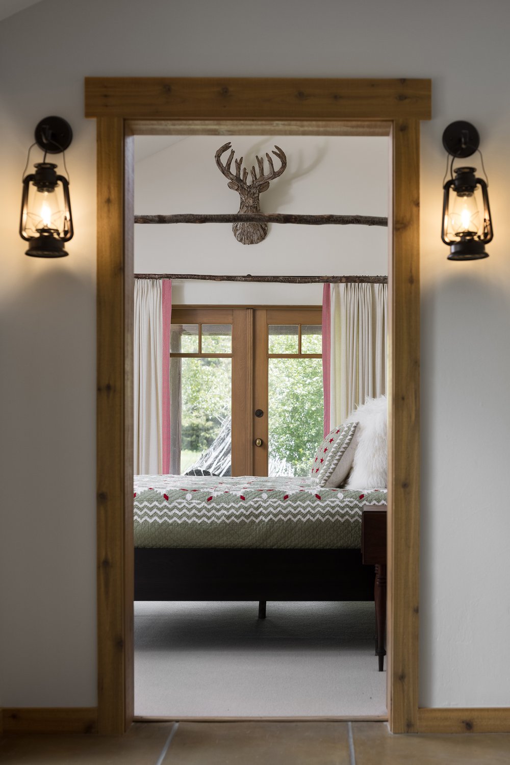 Bedroom door framed by lantern light sconces