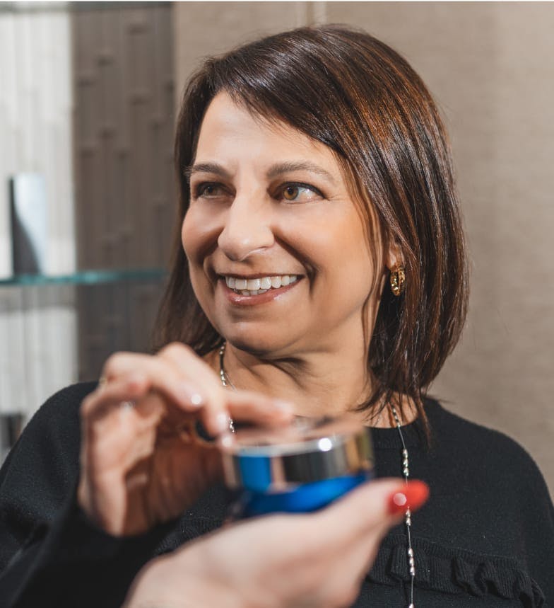 woman smiling while touching a metal device