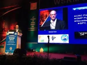 Dr. Zenn on stage making a speech