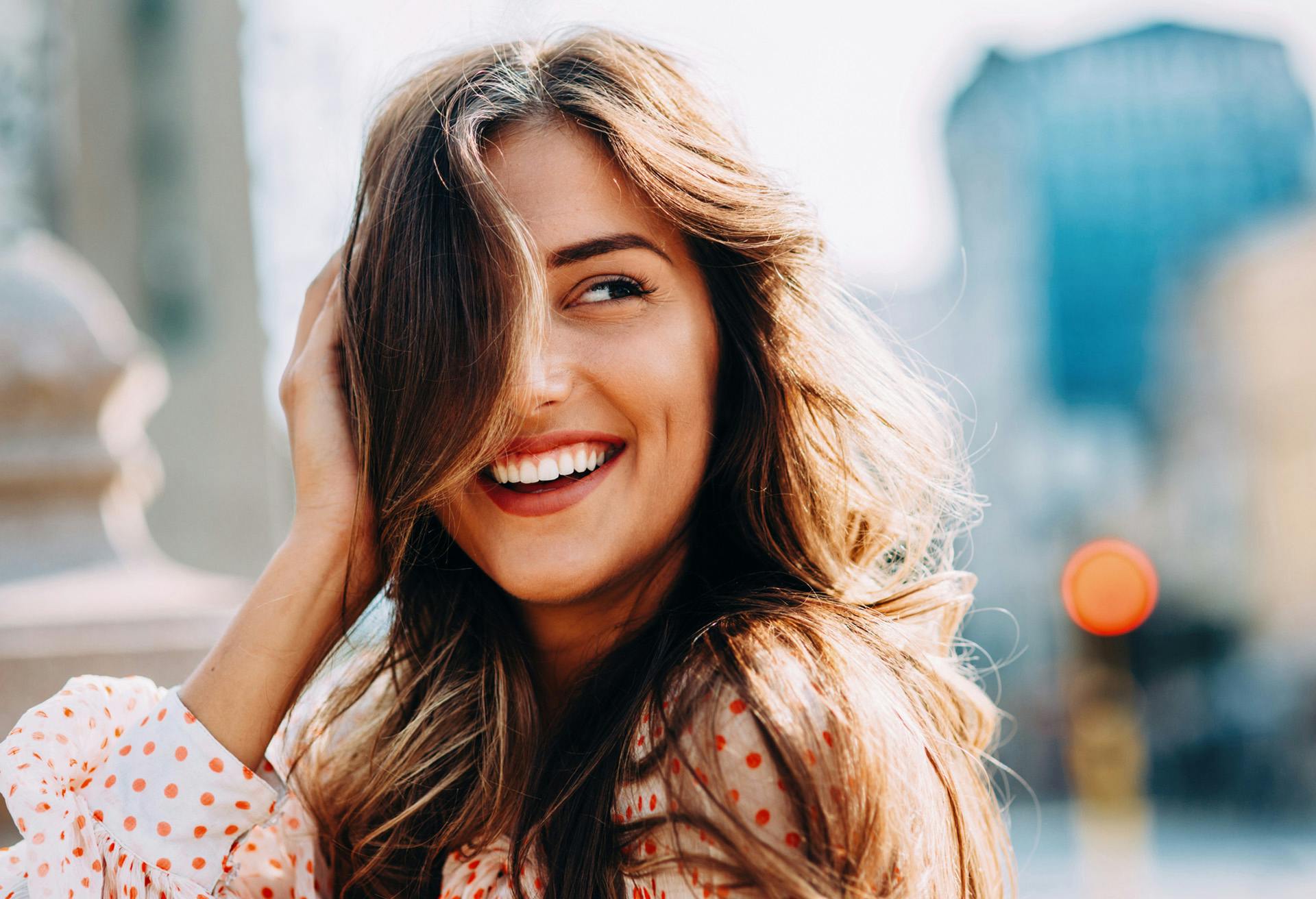 Woman smiling with her hand against her head