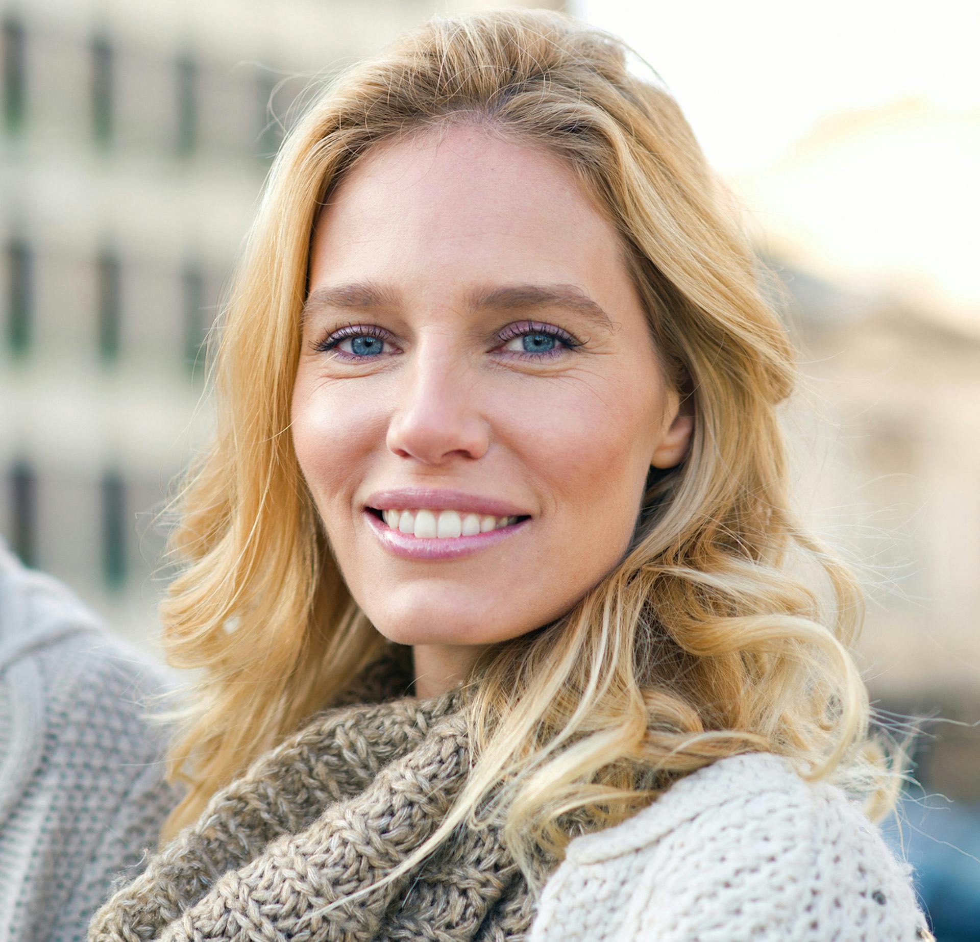 Woman with a scarf on smiling