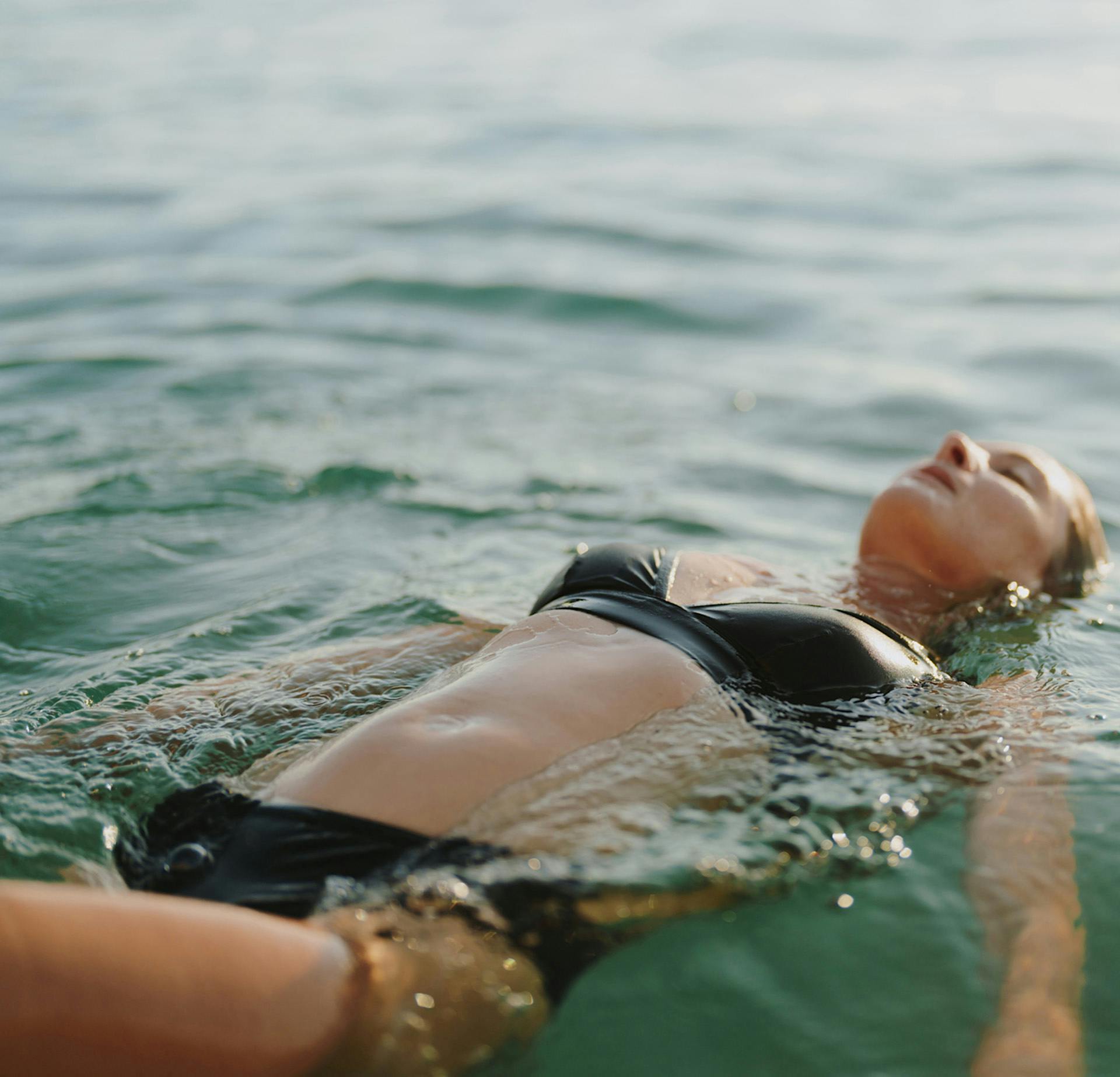 Woman floating on her back in water