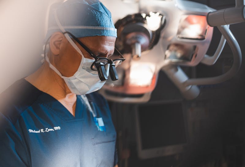 Dr. Zenn in an operating room with glasses on