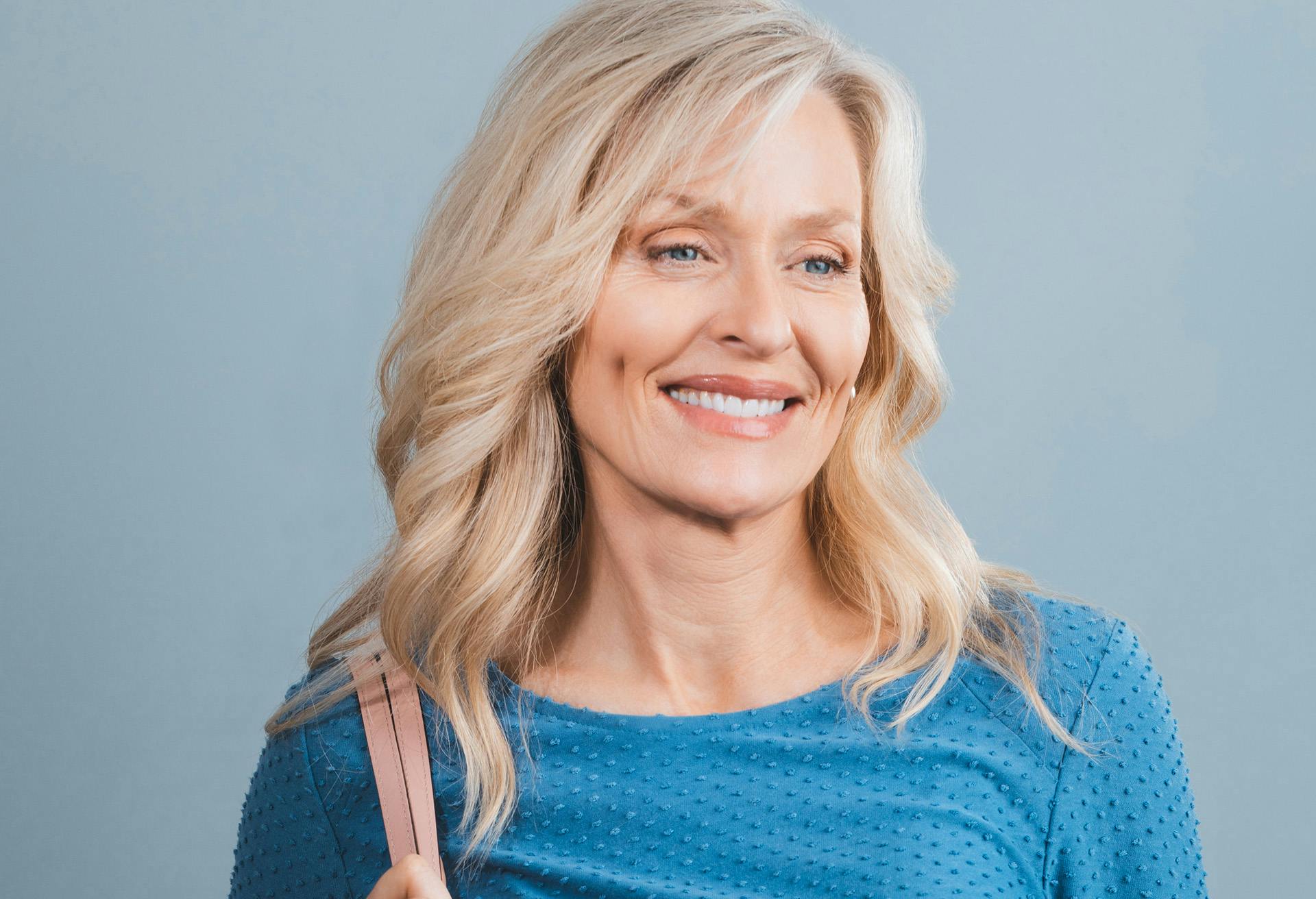 Woman in a blue shirt smiling