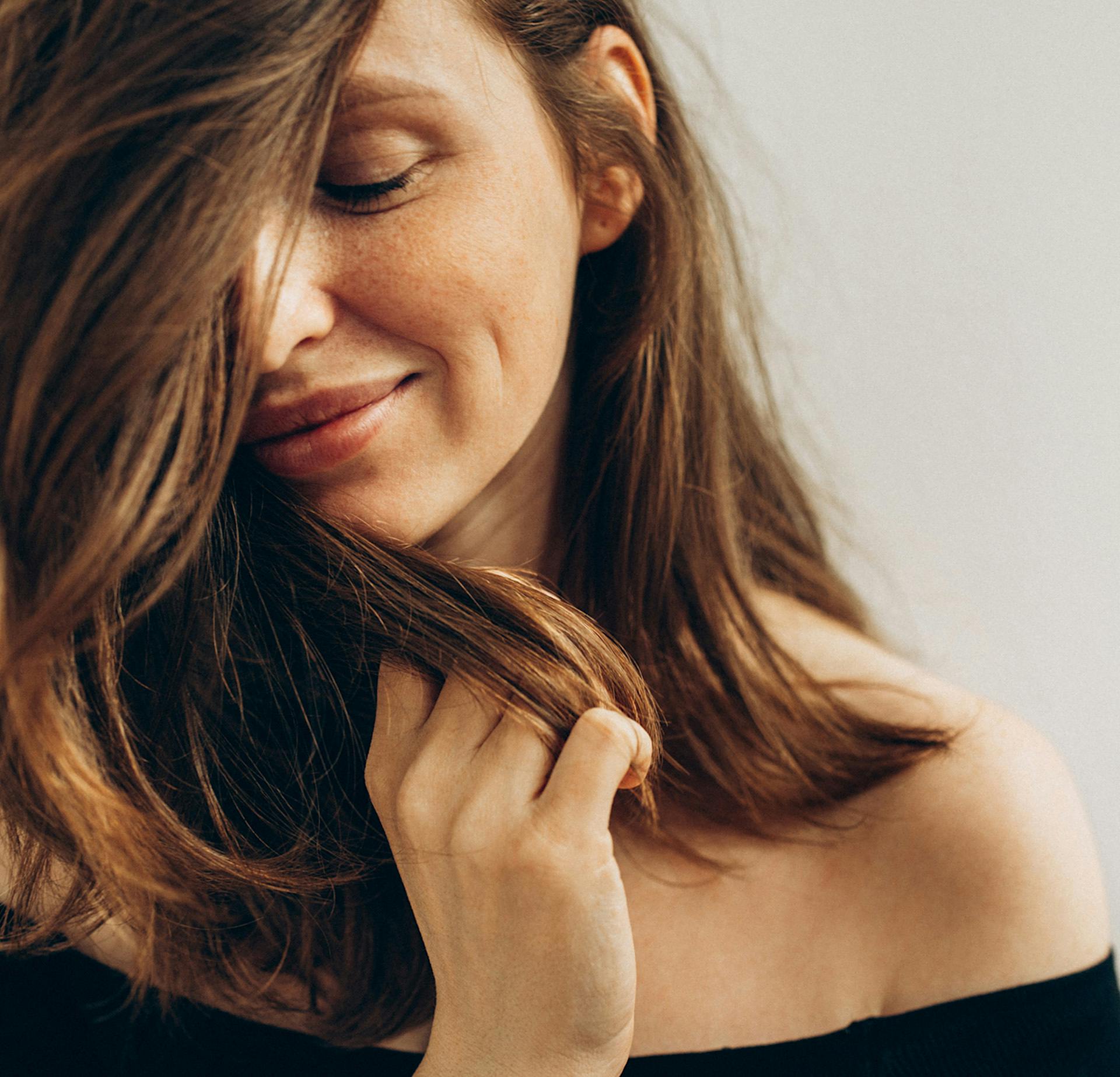 Woman with hair covering half of her face