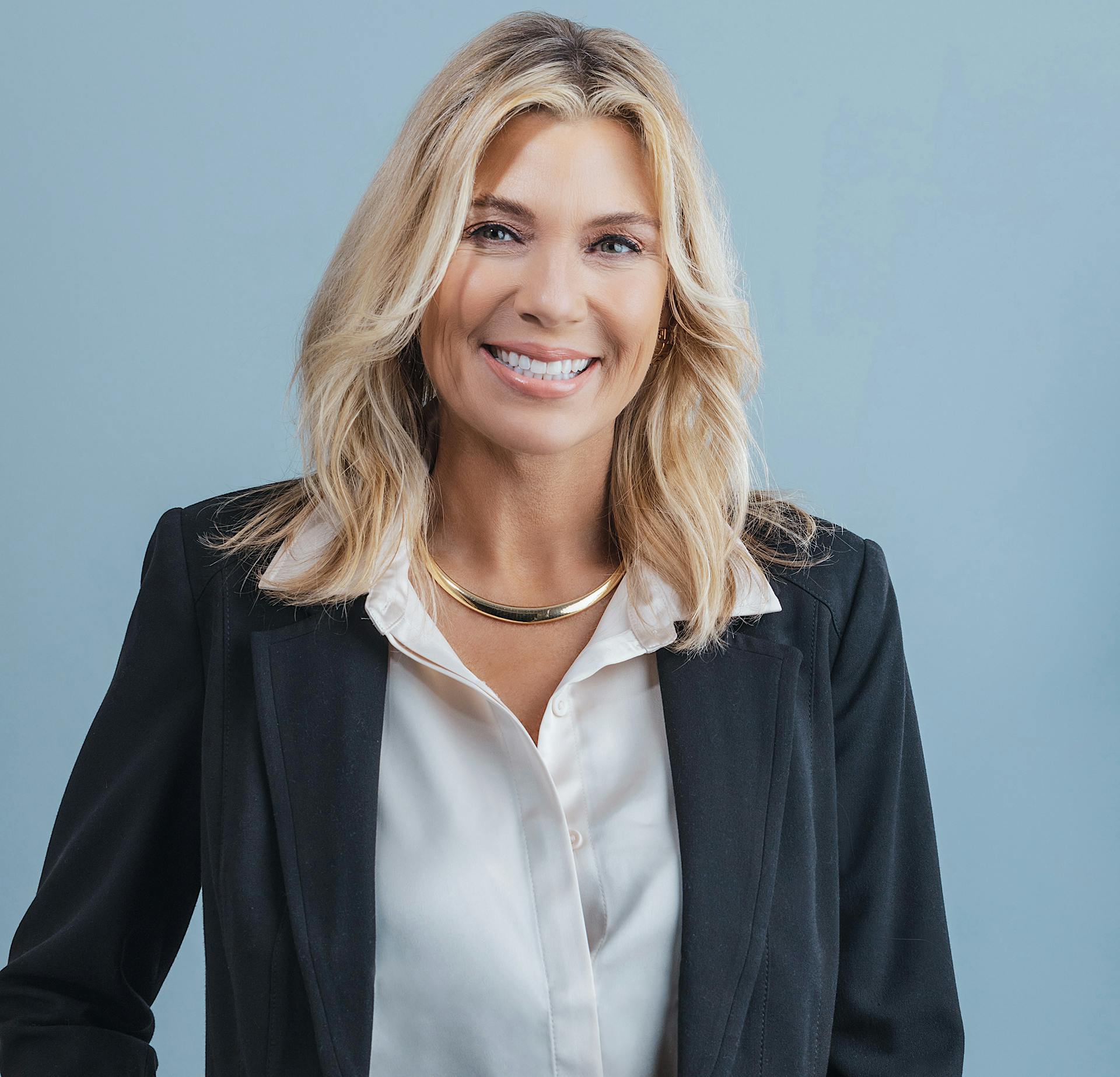 Woman in a black blazer smiling