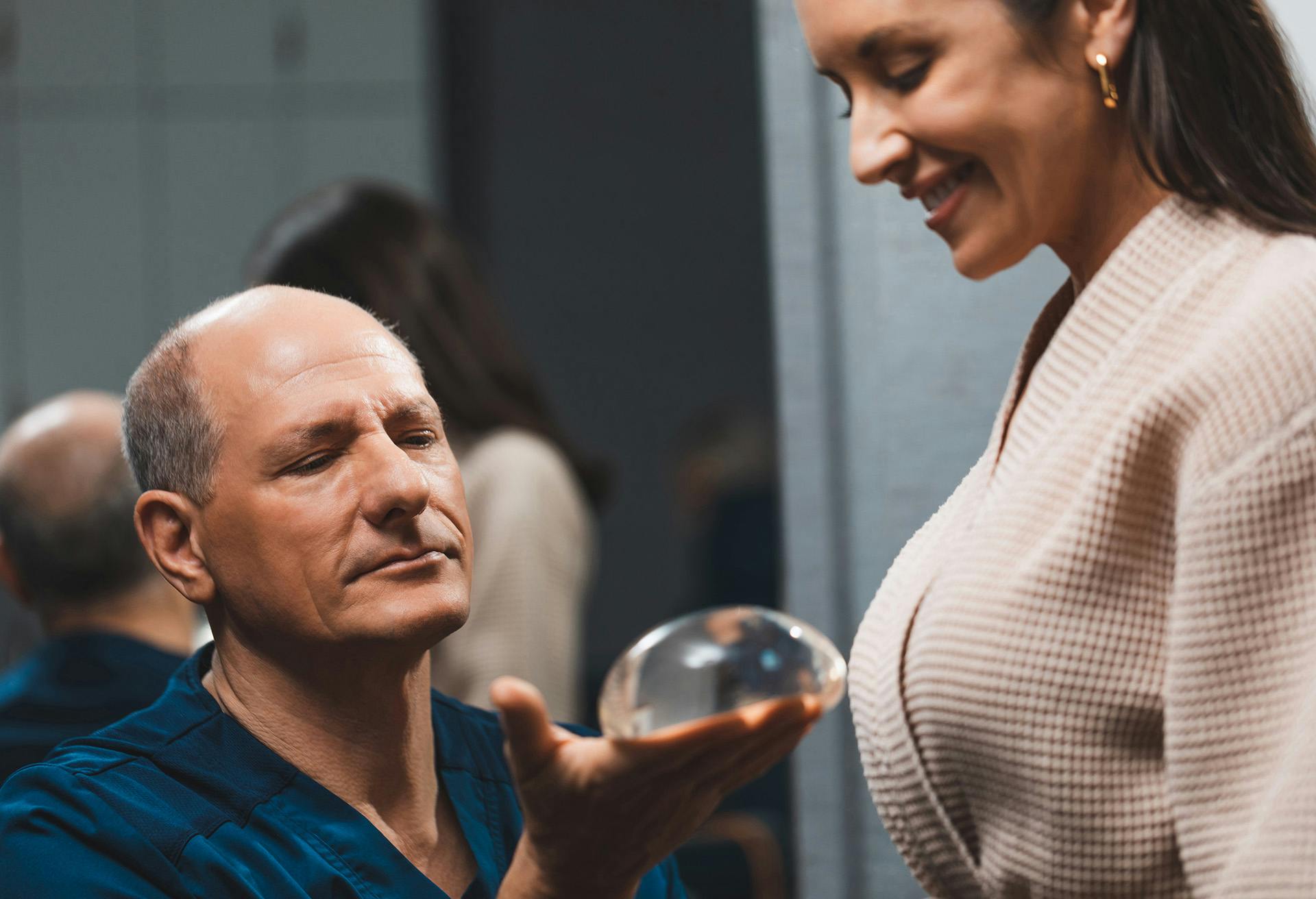 Dr. Zenn showing a patient a breast implant