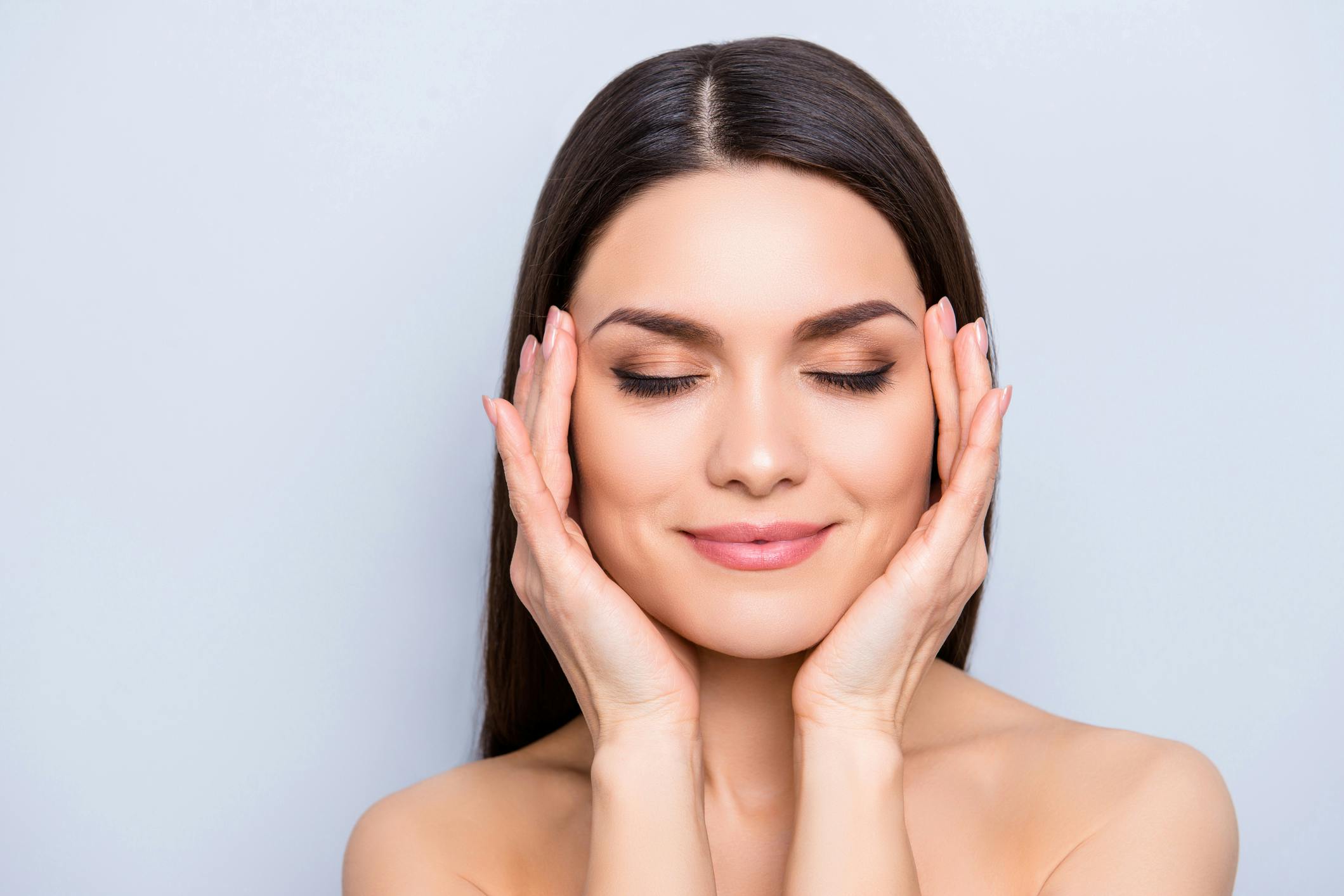 Woman with both hands on her cheeks