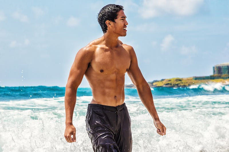 A shirtless man in the ocean