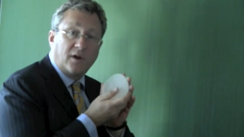 Dr. Teitelbaum holding a breast implant