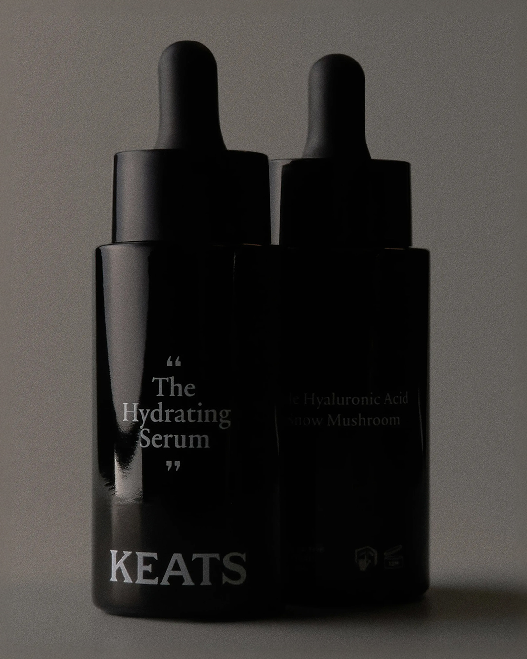 Keats two black dropper serum bottles side by side skincare product photography by Two Times Elliott