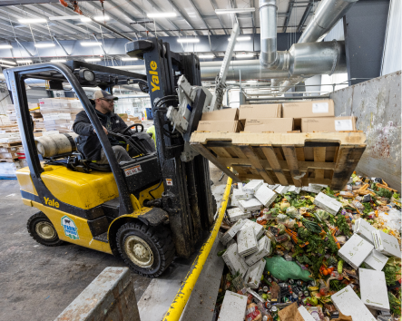 Depackaging waste at a organic waste recycling facility, preparing the food waste for farm powered anaerobic digestion