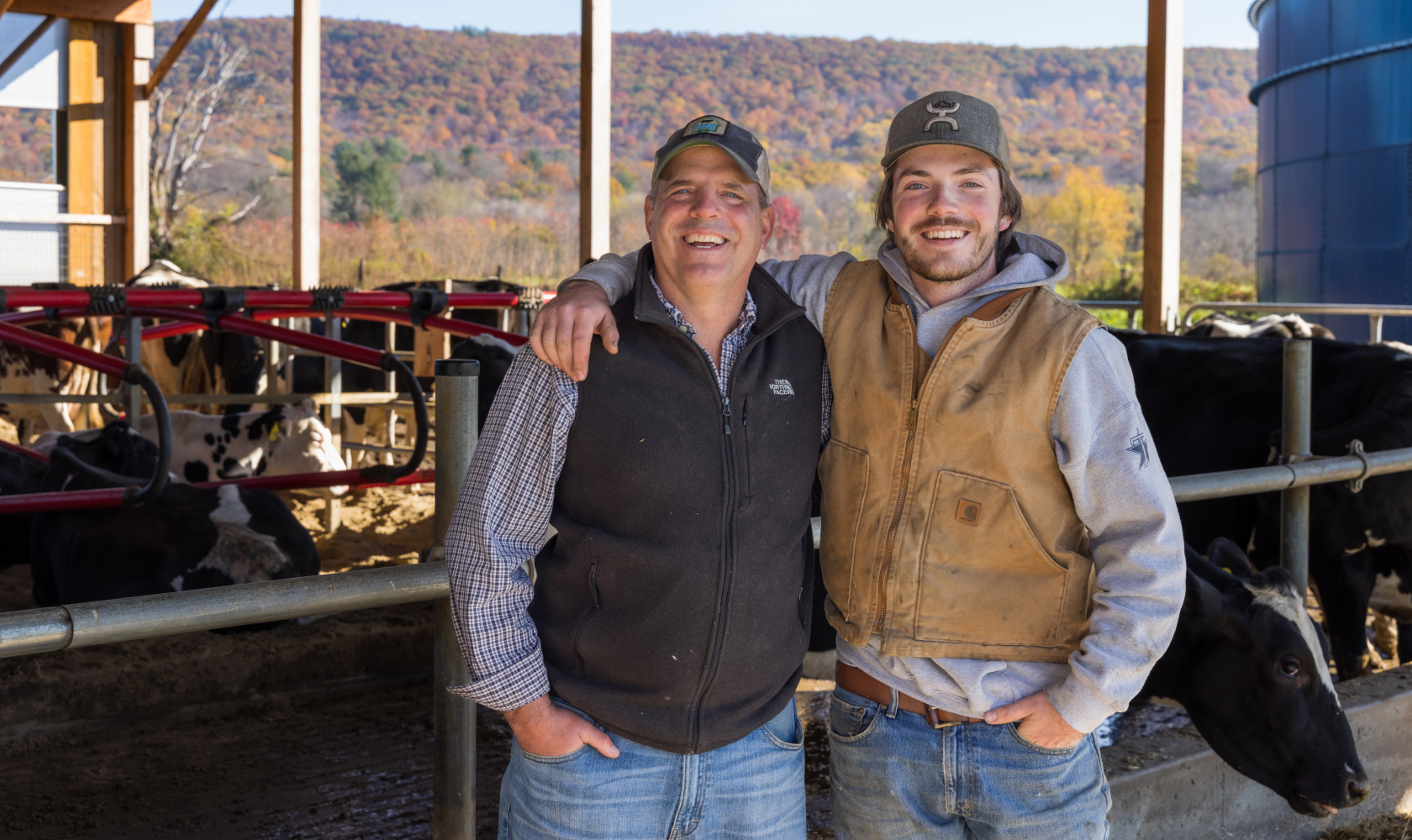 Two people on a dairy farm practicing regenerative agriculture through anaerobic digestion