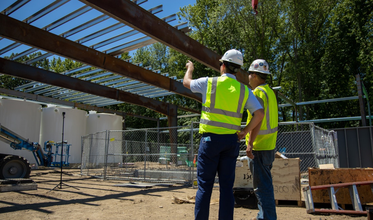 Two people working on waste management solutions