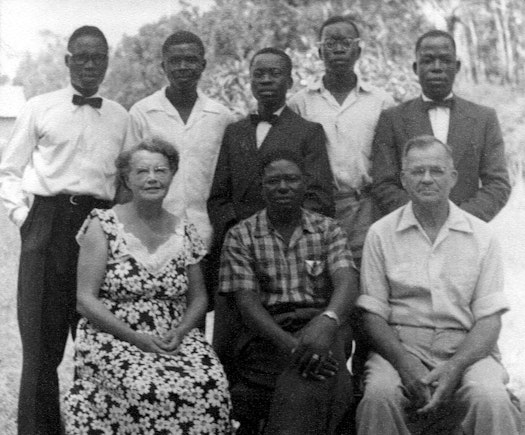 The first Bahá’í of Burundi, Selemani Bin Kimbulu (standing left), with other Bahá’ís including Mary Collison (front, left) and Reginald (Rex) Collison (front, right) Knight of Bahá’u’lláh for Ruanda-Urundi
