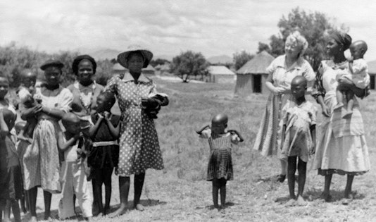 Elizabeth Laws, known as Mother of Love, with local people in Lesotho. They arrived on 13 October 1953, just three days before the end of the Holy Year at the beginning of a ten-year plan to take the Baha'i teachings around the world. For their services, they each received the accolade, Knight of Bahá’u’lláh, from Shoghi Effendi