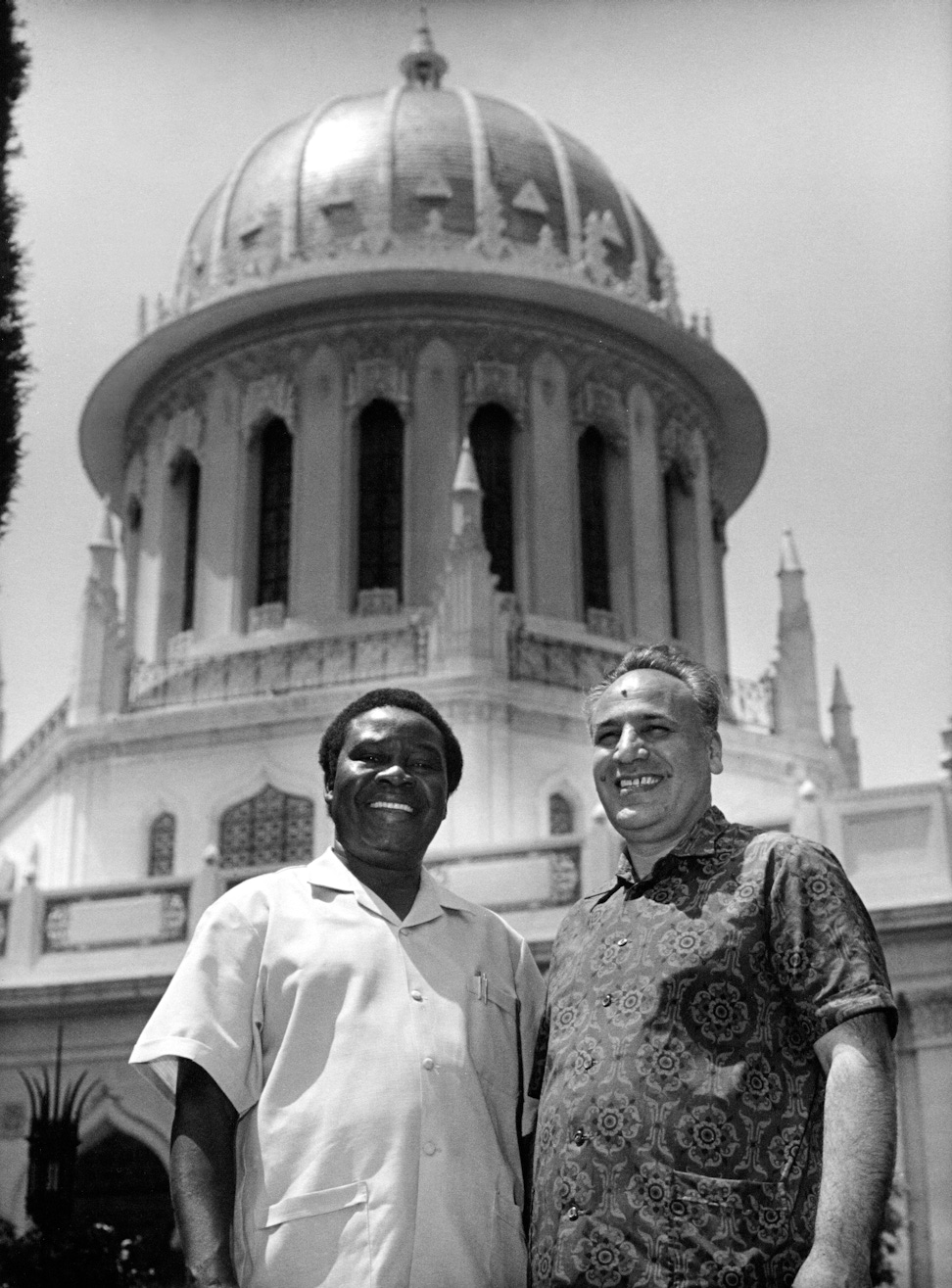 Hands of the Cause Enoch Olinga (left) and Rahmatu’lláh Muhájir (right) in front of the Shrine of the Báb, 1973