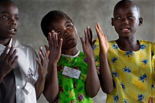 Girls singing prayers at the opening of an Arts Festival organized by the Bahá’í Community in Eldoret, Kenya