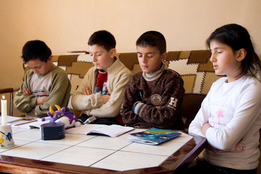 Youth saying prayers before starting their Baha'i junior youth study group