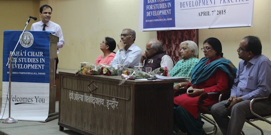 Bahá’í representative (at the podium) presents at the seminar Applying Spiritual Principles and Scientific Methods to Development Practice, organized by the Bahá’í Chair for Studies in Development at Devi Ahilya University in Indore, India