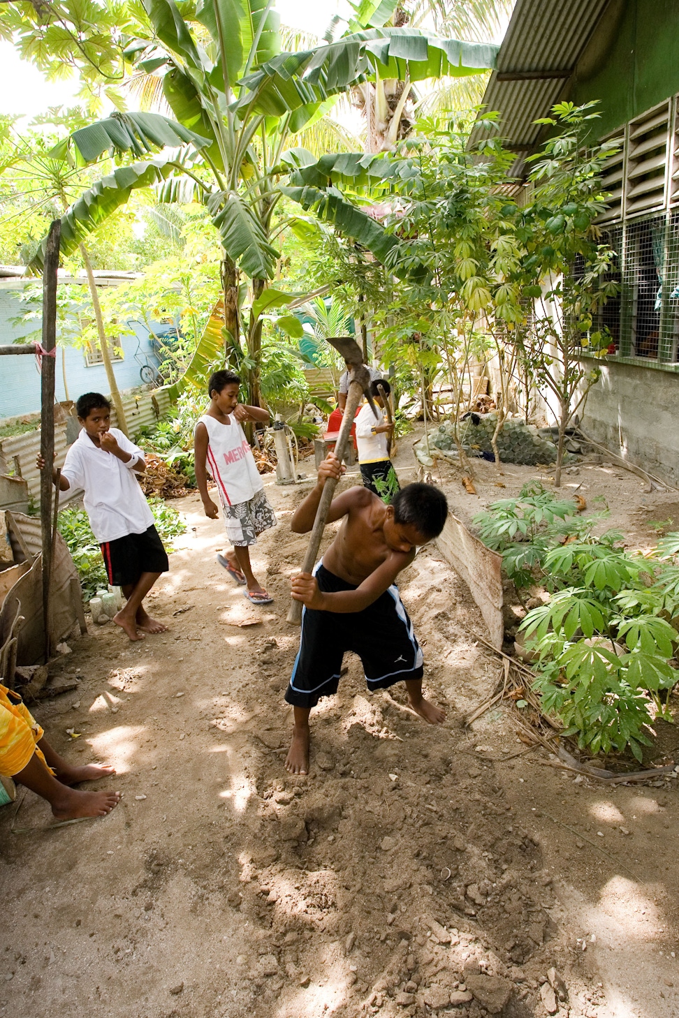 A group of youth making a garden as part of a service project for their Junior Youth Spiritual Empowerment Program in South Tarawa, Kiribati