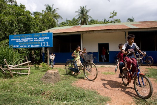 Students leaving a CORDE Center of Learning established by Cambodian Organization for Research, Development and Education, a Bahá'í-inspired organization in Battambang, Cambodia, focused on education