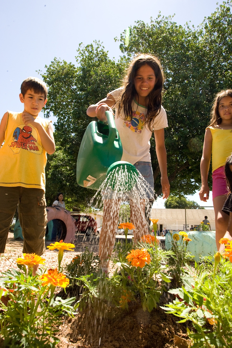 A group of youth making a garden as part of a service project for their Junior Youth Spiritual Empowerment Program in Canoas, Brazil