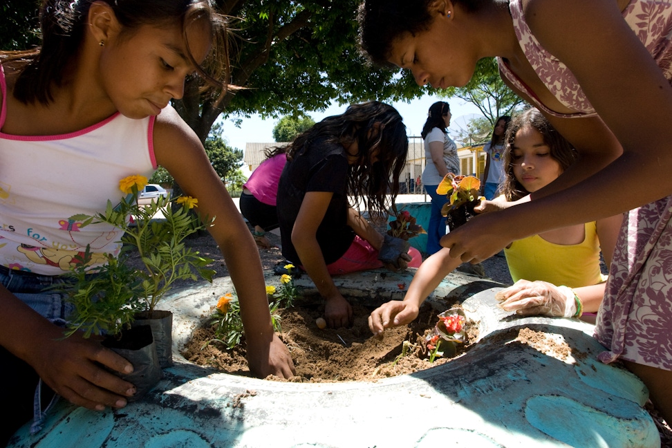 A group of youth making a garden as part of a service project for their Junior Youth Spiritual Empowerment Program in Canoas, Brazil