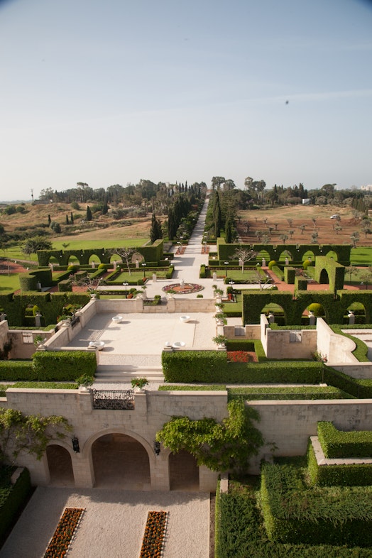 Entrance plaza gatehouse with the Shrine of Bahá’u’lláh in the distance