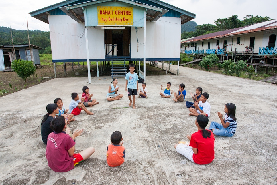 A children's class being held outside the Bahá’í centre in Kampung Belimbing Besi in Sarawak, Malaysia