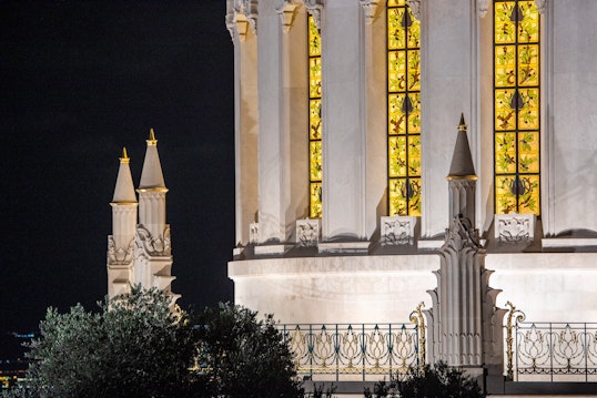 Pinnacles, wrought iron balustrade and lit lancet windows
