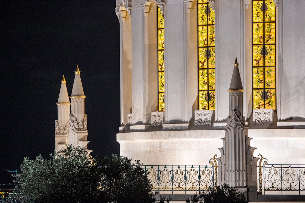 Pinnacles, wrought iron balustrade and lit lancet windows