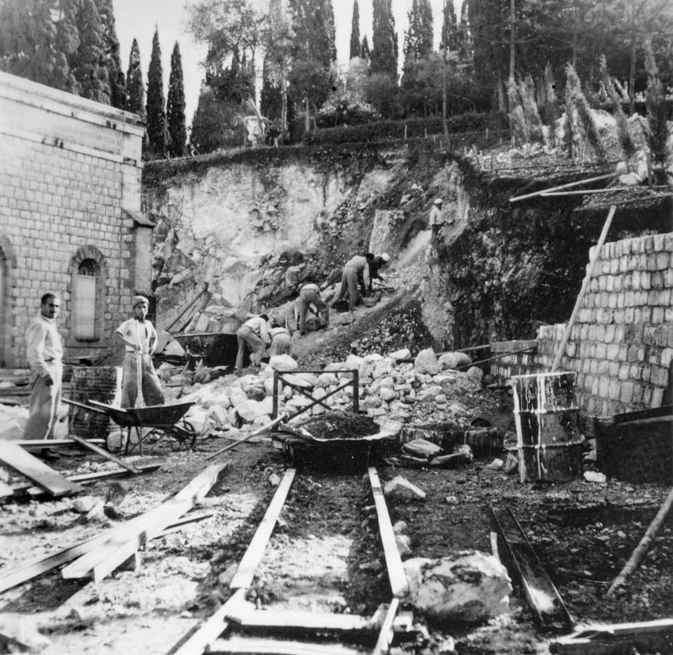 Workmen constructing the retaining wall behind the Shrine of the Báb, 1948