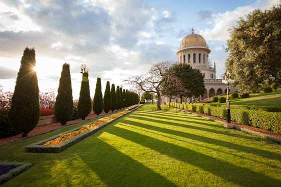 Looking at the Shrine of the Bab and its surrounding gardens at sunrise from the west